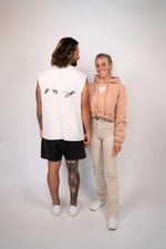 Two people standing side by side against a plain background