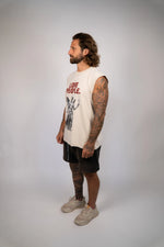 Man wearing a sleeveless shirt with text and graphics on a plain background