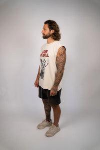 Man wearing a sleeveless shirt with text and graphics on a plain background