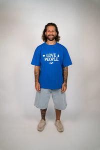 Man wearing a blue t-shirt with 'LOVE PEOPLE' text on a plain background