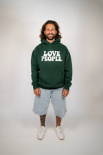 Man wearing a green hoodie with 'LOVE PEOPLE.' text on a plain background
